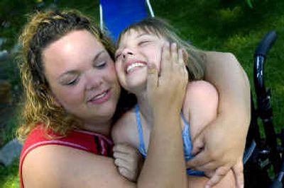 
Jeannine Thorpe hugs her daughter Ce'Nedra Thorpe, 11, whose specially designed tricycle was stolen from the porch of her family's North Side home last week.
 (Colin Mulvany / The Spokesman-Review)