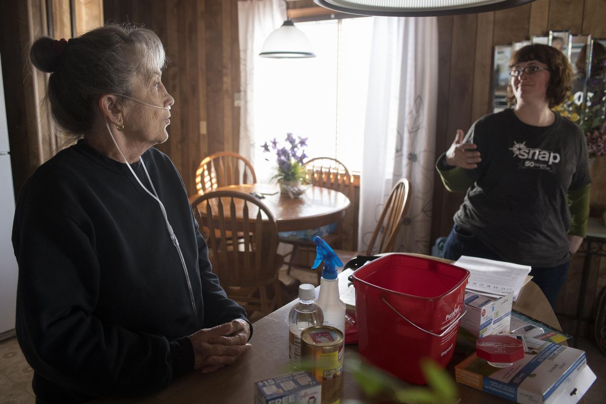 Client Teri Stockner, left, chats with Kim Kreber of SNAP, who helped her with a Healthy Homes assessment last Tuesday. The Healthy Home program, which piggybacks on SNAP’s weatherization program, helps people find unhealthy things, like toxic cleaners or dirty heating and cooling systems, in clients homes. Kreber brought healthier cleaning alternatives, some of which are on the counter in front of Stockner. Stockner has COPD and asthma, so clearing the air will help her breathe easier. (Jesse Tinsley/THE SPOKESMAN-REVIEW)