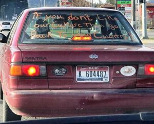 A red Nissan Sentra with mixed messages was spotted on Highway 41, southbound toward I-90, earlier this week. (Sam Taylor/Facebook photo)