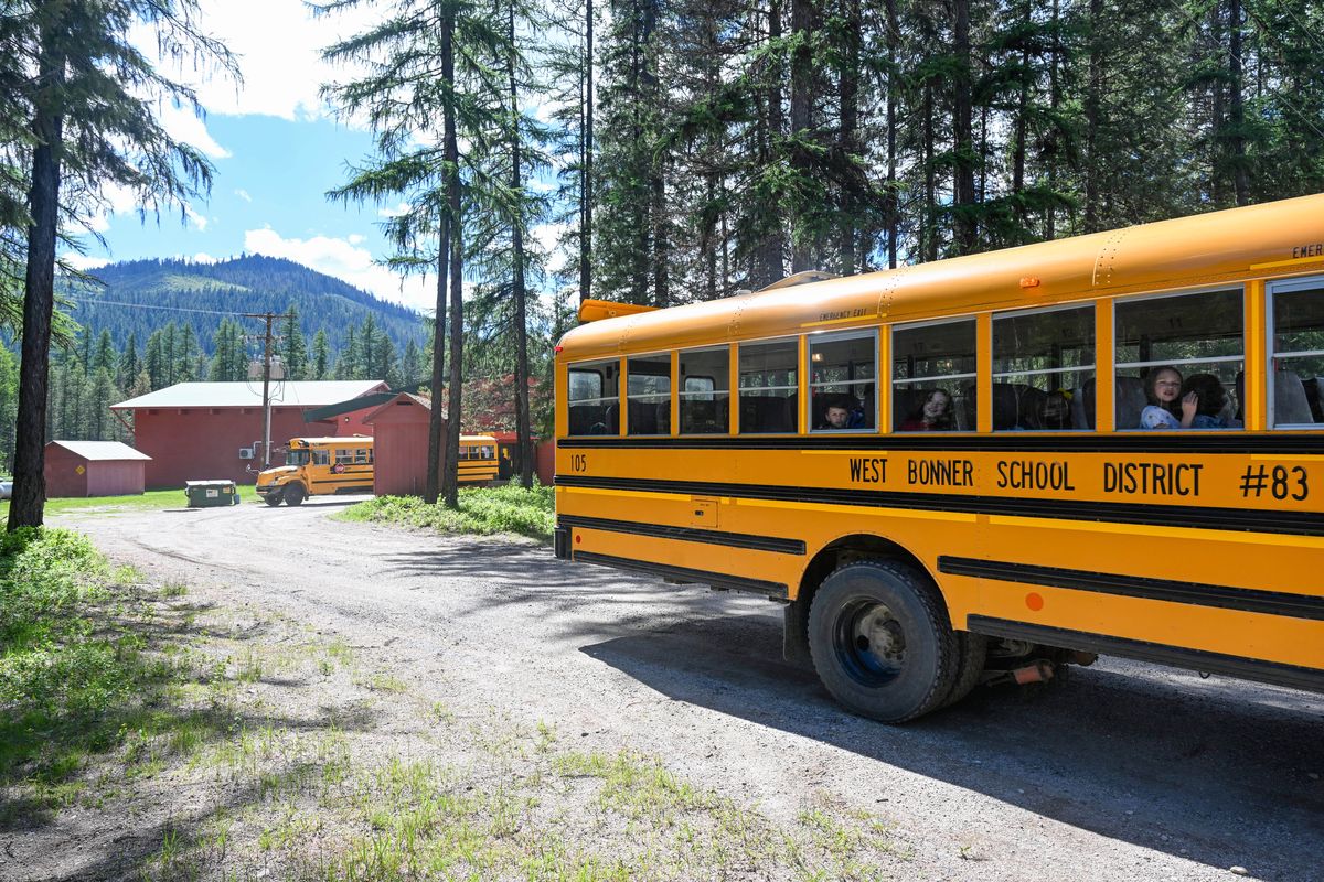 School buses leave Priest Lake Elementary, shown Wednesday, June 5, 2024 from the rural school in Bonner County, which could be closed if the West Bonner County School District votes to close it in response to a sizable funding shortfall.  (Jesse Tinsley/THE SPOKESMAN-REVI)