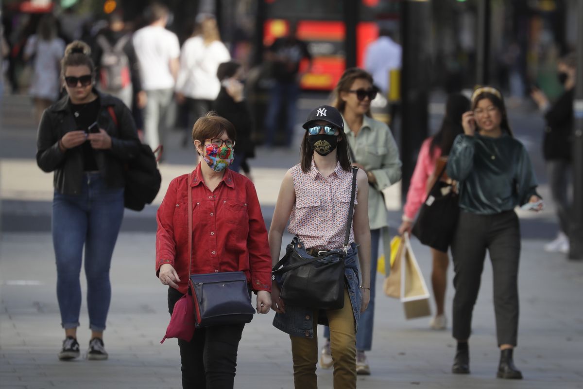 Shoppers wear masks on Oxford Street in London, Monday, Sept. 21, 2020. Britain