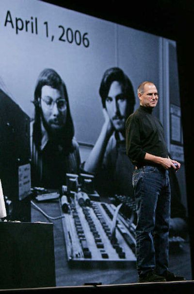 Apple Computer Inc. CEO Steve Jobs, right, smiles as a 30 year old photo of himself, right, and co-founder Steve Wozniak, left, is shown at the MacWorld conference earlier this year. 
 (Associated Press photos / The Spokesman-Review)