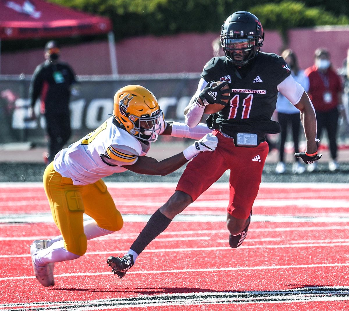 Eastern Washington wide receiver Freddie Roberson wiggles out of the grasp of Idaho cornerback Marcus Harris in their game Saturday in Cheney.  (DAN PELLE/THE SPOKESMAN-REVIEW)