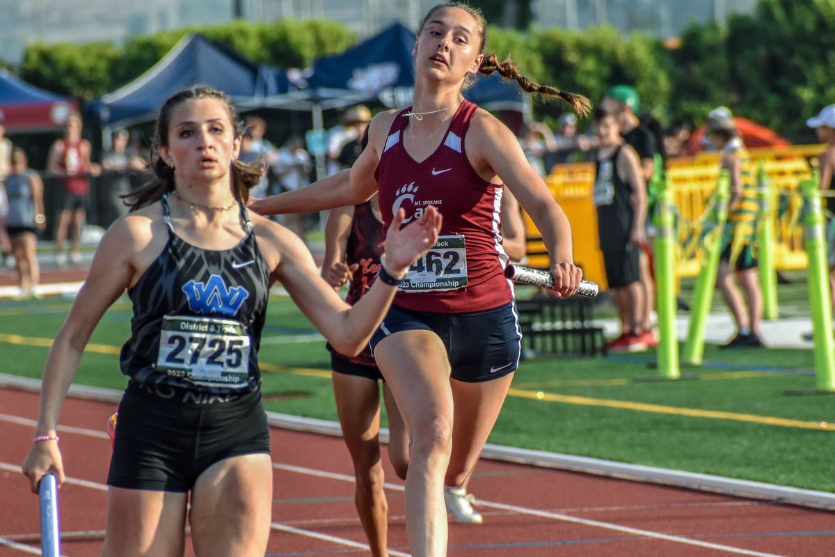Mt. Spokane’s Karissa Lindner, right, tries to catch Walla Walla sprinter Ashlyn Nielsen during the 4x100 relay at the District 8 4A/3A track and field championships in Richland.  (Keenan Gray/FOR THE SPOKESMAN-REVIEW)