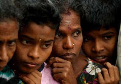 
Tsunami victims wait for aid in a camp south of Batticaloa, Sri Lanka, on Sunday. 
 (Associated Press / The Spokesman-Review)