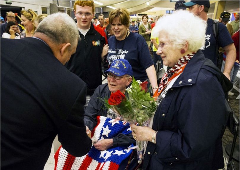 George Periman, middle, a United States Air Force Korean War veteran is welcomed home at the Spokane International Airport by supporters on Tuesday. Perlman was escorted by his wife Lee Periman, right, Shari McKinley, middle, and grandson Trevor McKinley. (Loren Benoit/CDA Press photo)