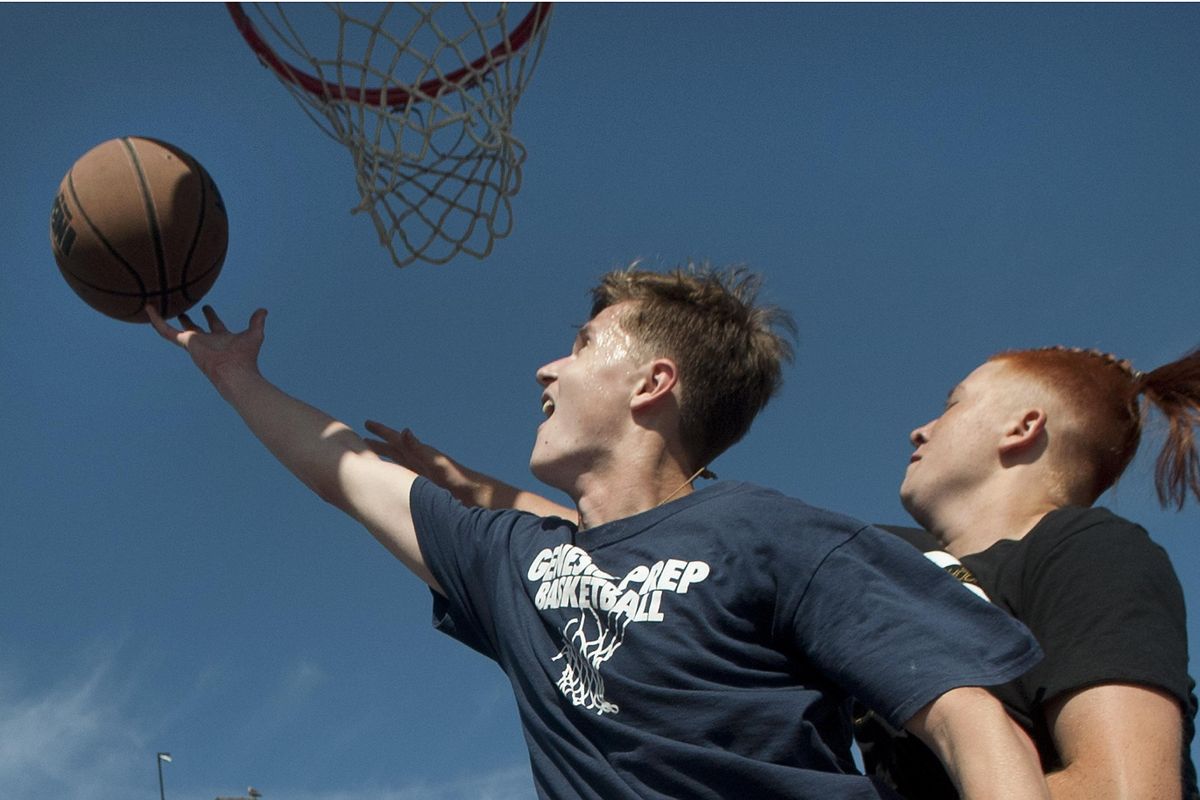 Genesis Prep Academy senior Jacob Peterson, left goes for a shot against sophomore Tristan Snowder during the "Kix For Kids" fundraiser at McEuen Park in Coeur d