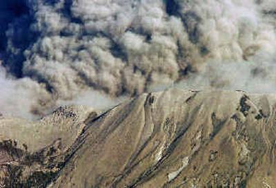 
Mount St. Helens exhales a cloud of steam and ash on Tuesday, as seen in this aerial photo. 
 (Associated Press / The Spokesman-Review)