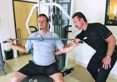 
Personal trainer Arthur Shaw works with client Karl Smith at  Exercise Solutions. 
 (J. BART RAYNIAK / The Spokesman-Review)