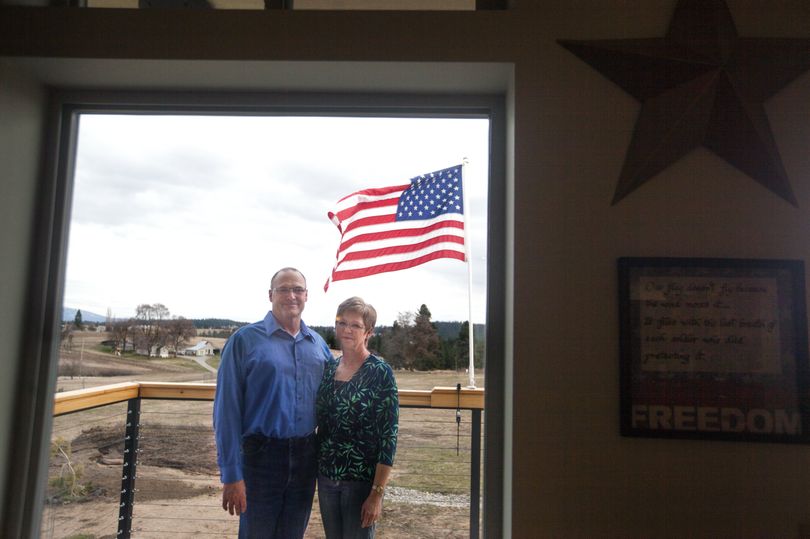 Mark and Terri Stiltz pose for a photo on their deck on March 27, with the flag they fly to honor their son Matt Stiltz, who died Nov. 12, 2012, in Afghanistan. (Tyler Tjomsland)