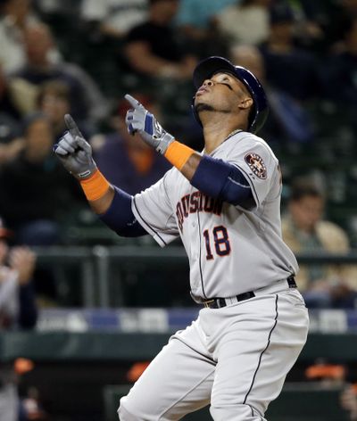 Luis Valbuena points skyward as he crosses home in the eighth after his second home run of the game. (Associated Press)