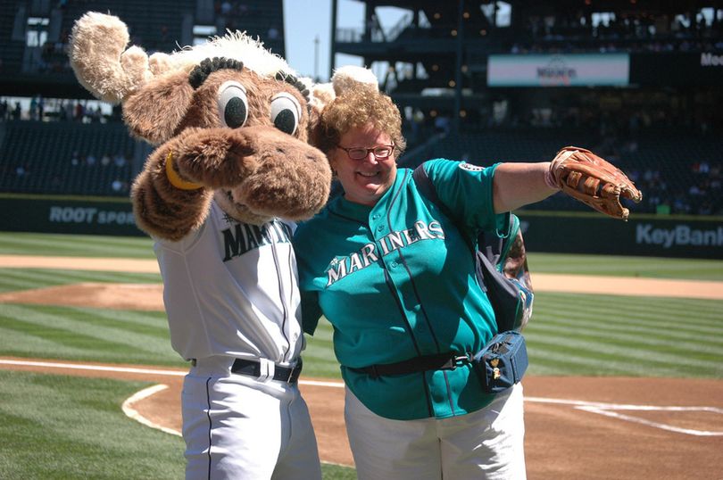 Mary Fairhurst with the Mariner Moose, the mascot of the Seattle Mariners. She sent this photo as her 2011 Christmas card with the words “Believe in Miracles” written on the front. She explained: “When I got rediagnosed (with cancer), my brothers and sisters were concerned and upset. I said, ‘I believe in miracles, you guys. It’s going to be OK.’ ”