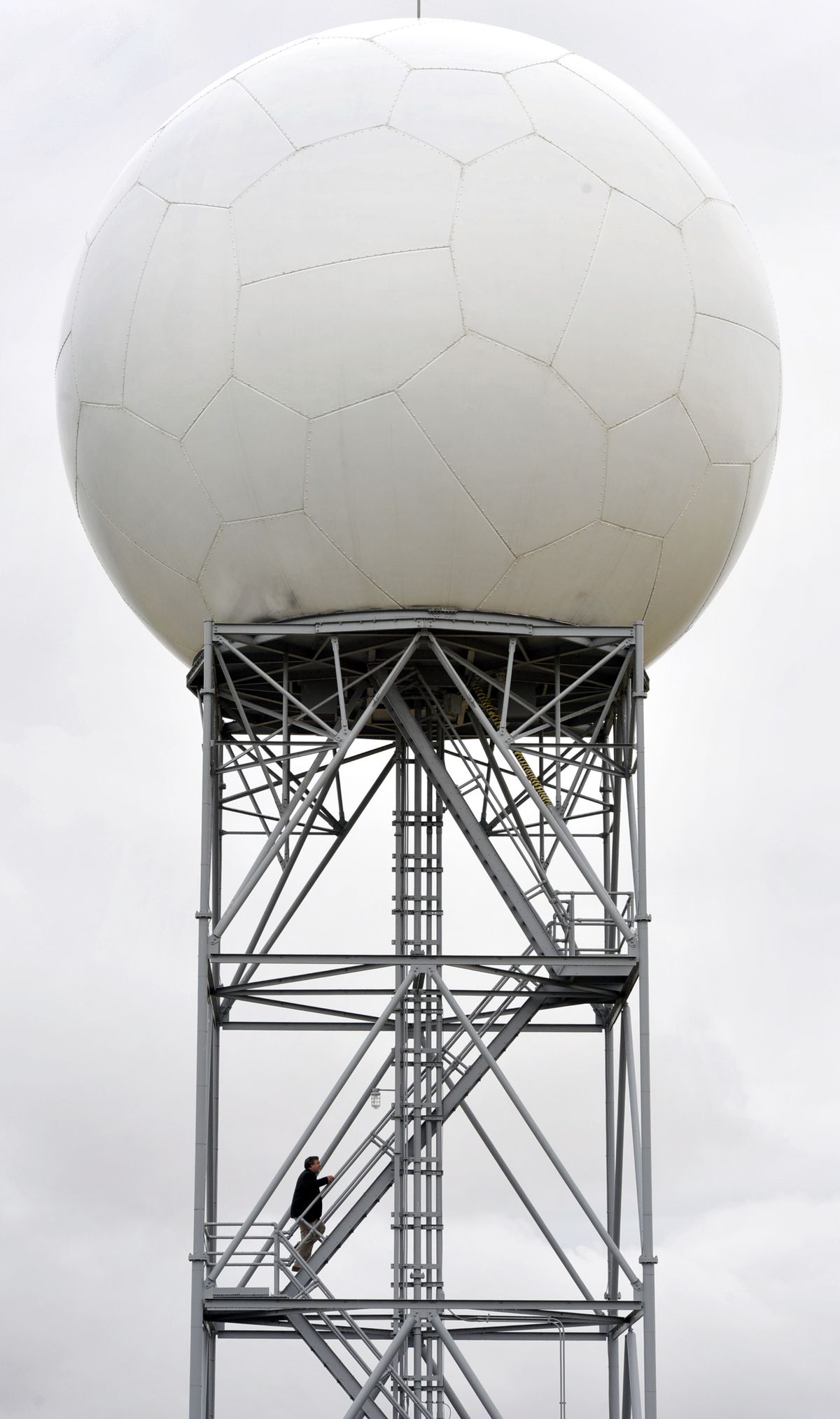 John Livingston, meteorologist in charge at the National Weather Service in Spokane, climbs the stairs of the Doppler radar tower near Airway Heights. (Dan Pelle)