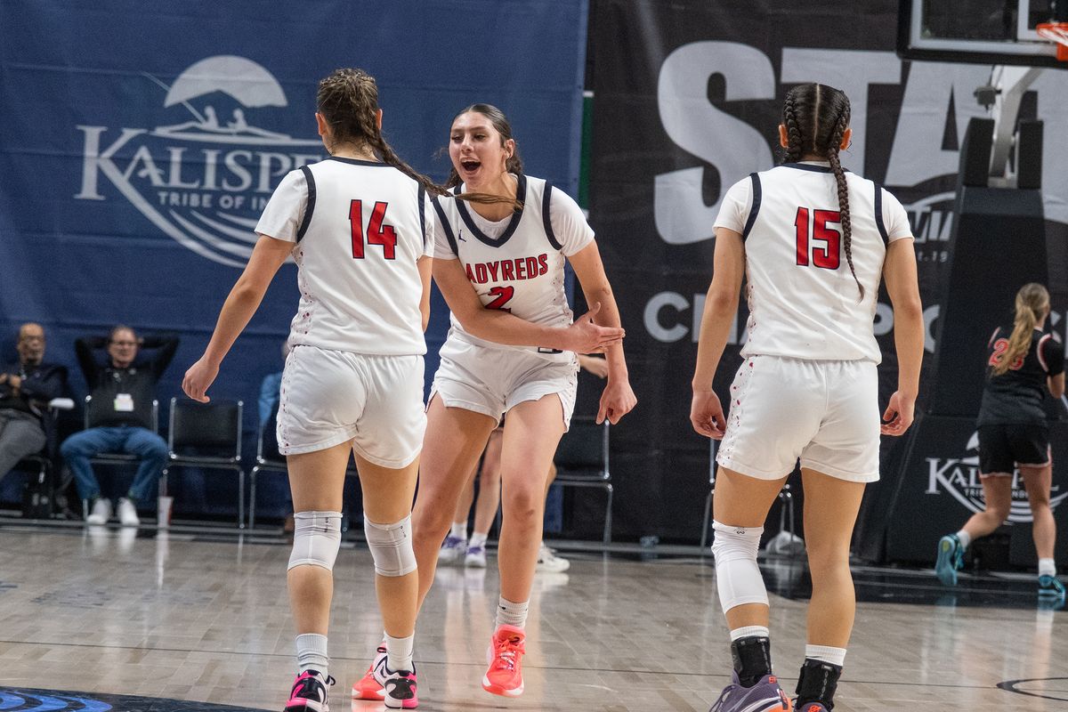 Neah Bay’s Angel Halttunen, facing, celebrates after forcing a Garfield-Palouse turnover during the State 1B girls championship game on Saturday at the Arena.  (Madison McCord/For The Spokesman-Review)