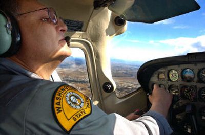 
Washington State Trooper John Montemayor flies above I-90 clocking speeds of cars east of the Sullivan exit. 
 (photos by Kathryn Stevens / The Spokesman-Review)