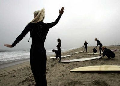 
Moms on Boards members stretch before surfing, a sport they say is physically demanding but also benefits them mentally and spiritually. 
 (Los Angeles Times / The Spokesman-Review)