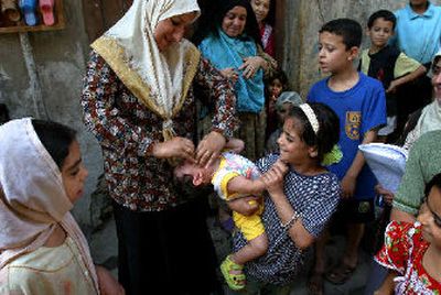 
Iraqi children are given polio vaccinations in Baghdad on Wednesday. 
 (Associated Press / The Spokesman-Review)