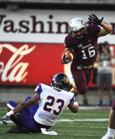 Montana wide receiver Jerry Louie-McGee  hurdles Northern Iowa defensive back A.J. Allen  during Saturday’s game in Missoula. (Colter Peterson / AP)