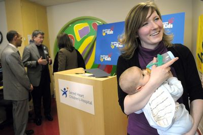Tara McCanna, a stay-at-home mother of two, holds her son Darren as  Sen. Maria Cantwell, left, meets with health care workers  Friday at Sacred Heart Children’s Hospital in Spokane.  (CHRISTOPHER ANDERSON / The Spokesman-Review)