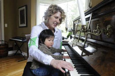 
Heidi Duffy of Spokane plays piano with her daughter, Elizabeth, 2, at their home. Duffy decided to hire a nanny for Elizabeth and her older brother and designed an interview process to screen candidates. 
 (Jesse Tinsley / The Spokesman-Review)