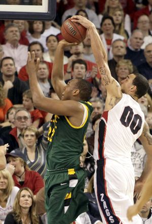 Gonzaga's Robert Sacre gets a hand on the ball as San Francisco's Perris Blackwell shoots during the second half of their NCAA college basketball game at the McCarthey Athletic Center in Spokane, Wash. Saturday, Feb. 27, 2010. Gonzaga beat San Francisco 75-69. (Rajah Bose / Fr120940 Ap)