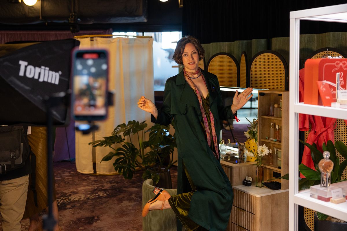 YouTube content creator Diana Extein displays her shoes to her phone camera during YouTube