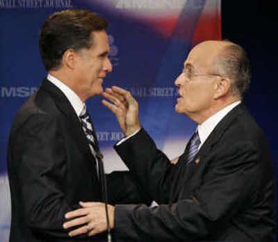 
Republican presidential hopefuls former Massachusetts Gov. Mitt Romney, left, and former New York City Mayor Rudy Giuliani talk  after Tuesday's GOP presidential debate in Dearborn, Mich. Associated Press photos
 (Associated Press photos / The Spokesman-Review)
