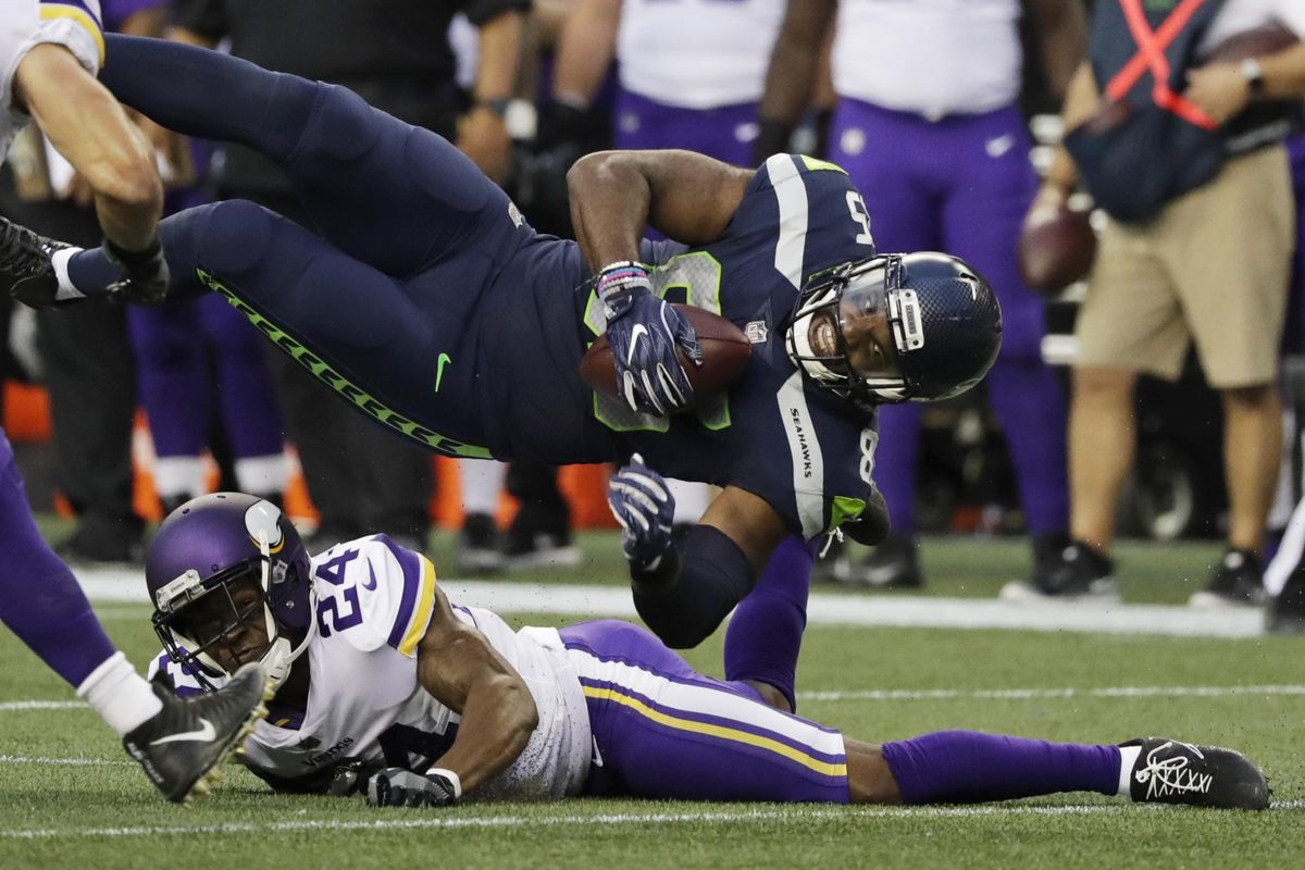 Seattle Seahawks tight end Marcus Lucas  gets sideways above Minnesota Vikings cornerback Jabari Price  after a reception during the first half  Friday  in Seattle. (Stephen Brashear / AP)