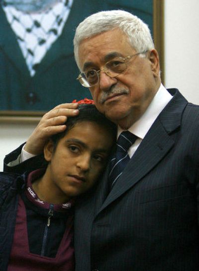 
Palestinian Authority President Mahmoud Abbas meets with Houda Ghalia in Gaza City on Saturday. Many members of the Palestinian girl's family were killed Friday by Israeli artillery.
 (Associated Press / The Spokesman-Review)