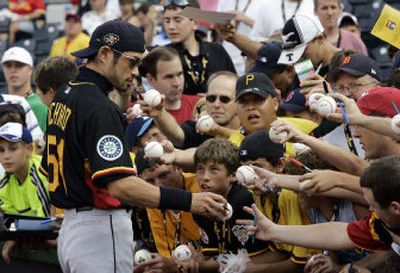 
Ichiro Suzuki of the Mariners, who will be making his sixth All-Star start, signs autographs before the All-Star Game Home Run Derby on Monday in Pittsburgh. 
 (Associated Press / The Spokesman-Review)