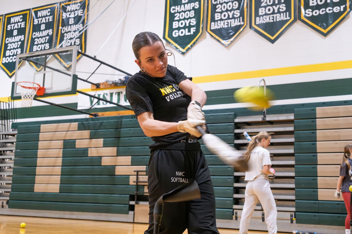 Northwest Christian senior Kaitlyn Waters takes some swings during a recent team practice inside her school’s gym.  (Madison McCord/For The Spokesman-Review)