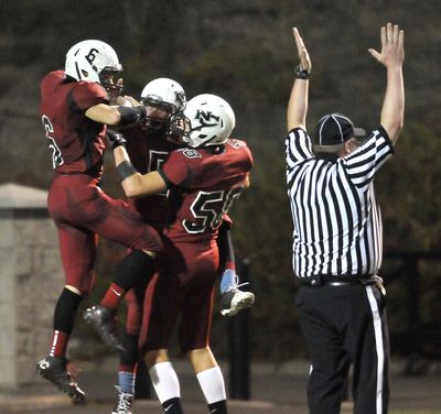 North Central’s Quinn Zerba, left, celebrates with teammates after a touchdown in the second half. (Jesse Tinsley)