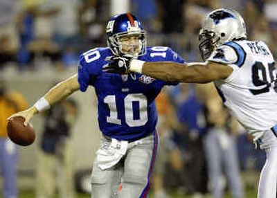 
Eli Manning (10) had a good game against Carolina but a subpar effort in his last start relegated him to the bench where he will play behind veteran Kurt Warner.
 (Associated Press / The Spokesman-Review)