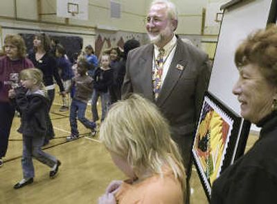 
Spokane Postmaster Edward Schierberl poses with Grant Elementary students and the new stamp unveiled at the school  Oct.  5. FILE 
 (FILE / The Spokesman-Review)