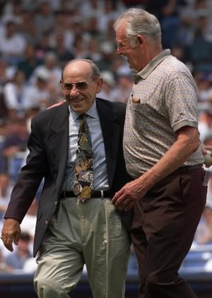 Yankee legend and catcher Yogi Berra, left, walks off the field arm in arm with former teammate Don Larsen, now of Hayden, after catching the ceremonial first pitch from Larsen before the New York Yankees game against the Montreal Expos during "Yogi Berra Day" Sunday, July 18, 1999, at New York's Yankee Stadium. Berra caught Larsen's perfect game no-hitter in the 1956 World Series. (AP Photo/Kathy Willens)