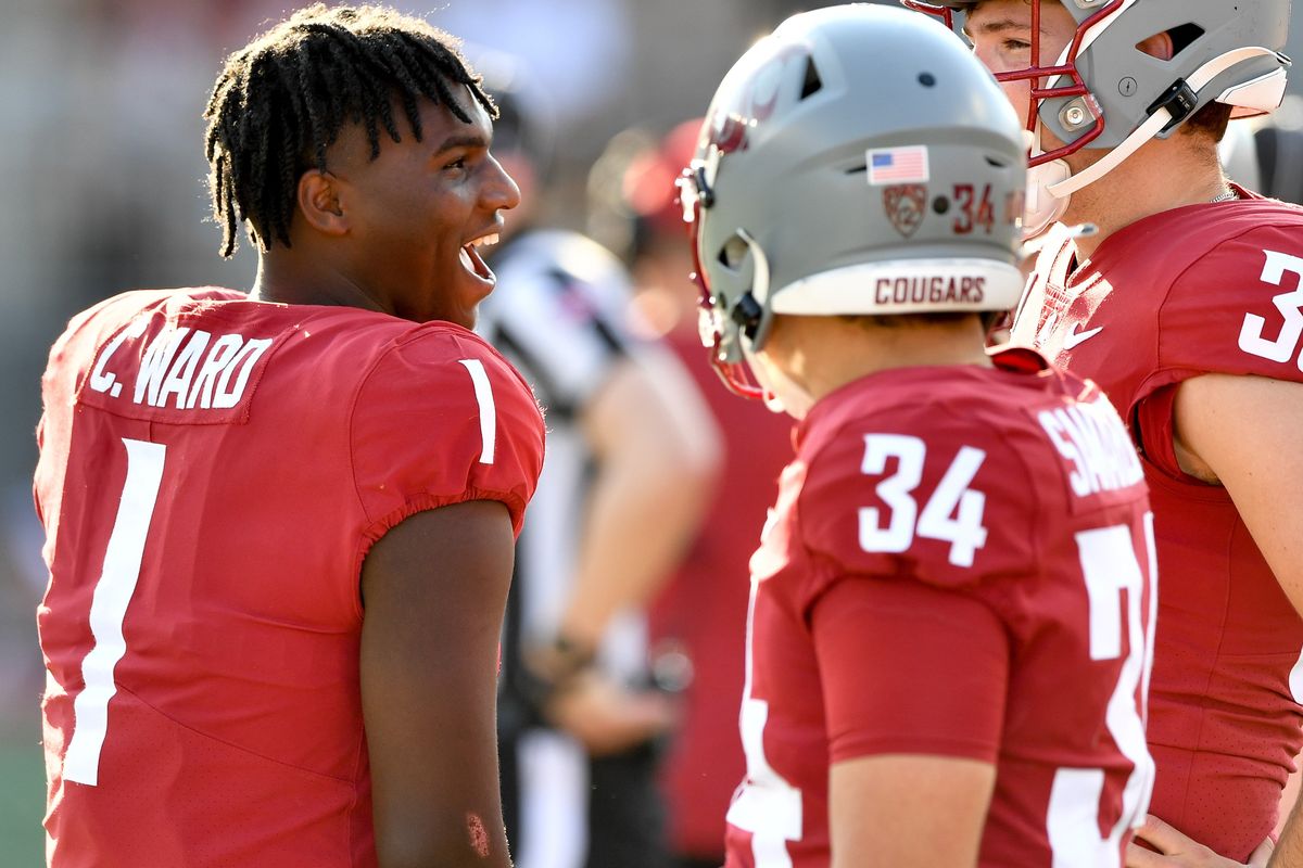 Washington State Cougars quarterback Cameron Ward (1) laughs with long snapper Simon Samarzich (34) and punter Nick Haberer (38) during the second half of a college football game on Saturday, Sept. 16, 2023, in Pullman, Wash. WSU won the game 64-21.  (Tyler Tjomsland/The Spokesman-Review)