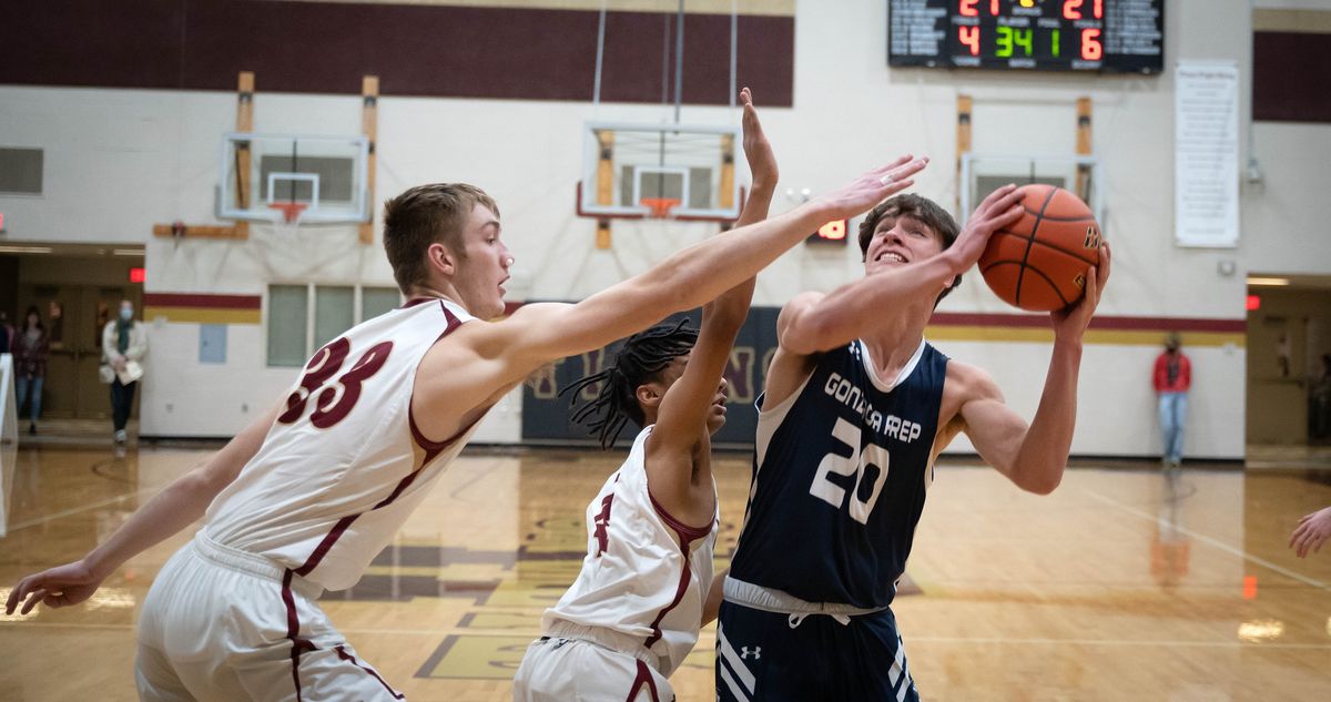 Gonzaga Prep’s Henry Sanberg (20) looks to the basket as University’s Conrad Bippes (33) defends in the key during a GSL high school basketball game, Friday, Dec. 10, 2021, at University High School.  (COLIN MULVANY/THE SPOKESMAN-REVIEW)