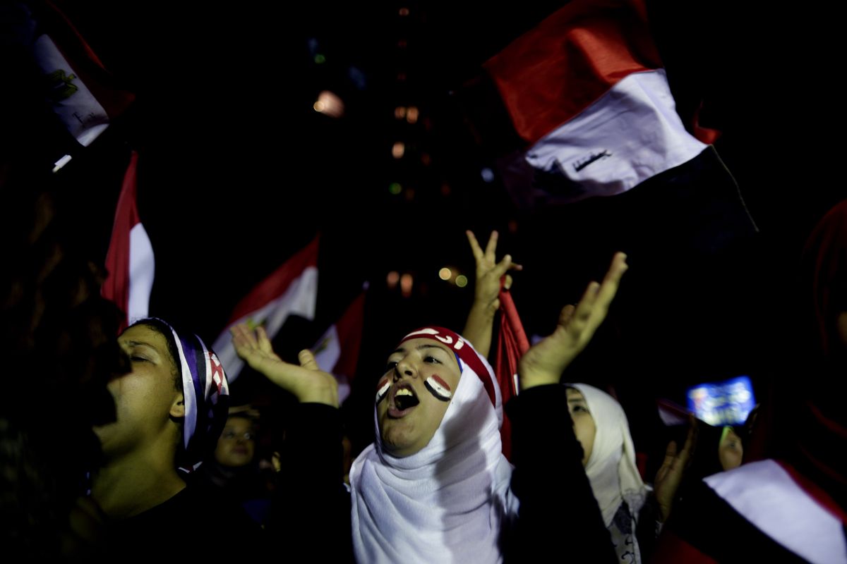 Opponents of Mohammed Morsi celebrate outside the presidential palace in Cairo on Wednesday. (Associated Press)