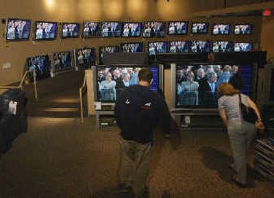 
Customers scrutinize large-screen televisions at a display in Long Beach, Calif.
 (Associated Press / The Spokesman-Review)