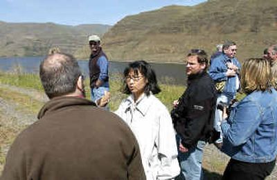 Artist and architect Maya Lin, center, talks with reporters and enthusiasts after the Nez Perce Tribal blessing ceremony along the banks of the Snake River at Chief Timothy Park, near Clarkston on Saturday.
(Associated Press / The Spokesman-Review)
