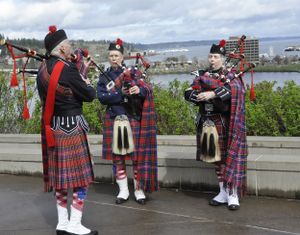 OLYMPIA -- Pipe Major Bill Collins, left, with Joby Wynans and Beverly York, all members of the Olympia Highlanders, practice on their bagpipes overlooking Capitol Lake and Budd Inlet before Tartan Day activities at the state Capitol. (Jim Camden/The Spokesman-Review)