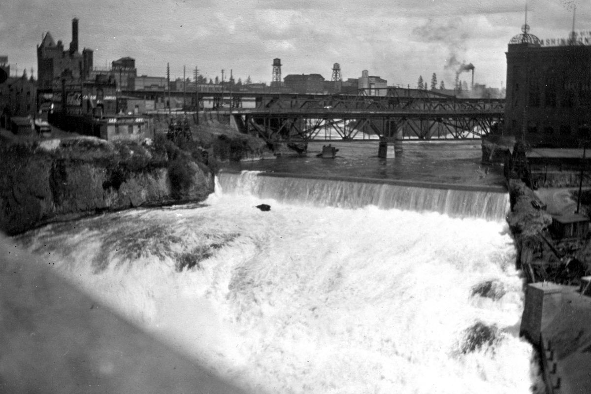 June 1914: The industrial skyline of early 20th-century Spokane shows buildings clustered around the falls and the Washington Water Power generating plant. (Photo archive)
