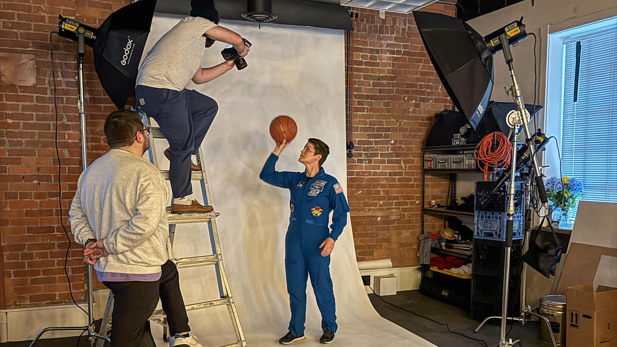 Propaganda Creative art director Shane Schantz, left, works with Propaganda Creative photographer/videographer Phillip Cockburn to capture a shot of McClain for a poster concept that would depict McClain as floating. (Courtesy of Propaganda Creative)