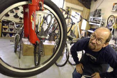 
John Kolbe eyeballs a new bike in his small shop, Pedal Pushers, in Harrison, Idaho. The former forester and aircraft mechanic is banking on the boom that the Trail of the Coeur d'Alenes – the rails-to-trails project that runs from Mullan to Plummer, through tiny Harrison – is bringing to the area. John Kolbe eyeballs a new bike in his small shop, Pedal Pushers, in Harrison, Idaho. The former forester and aircraft mechanic is banking on the boom that the Trail of the Coeur d'Alenes – the rails-to-trails project that runs from Mullan to Plummer, through tiny Harrison – is bringing to the area. 
 (Jesse Tinsley/Jesse Tinsley/ / The Spokesman-Review)