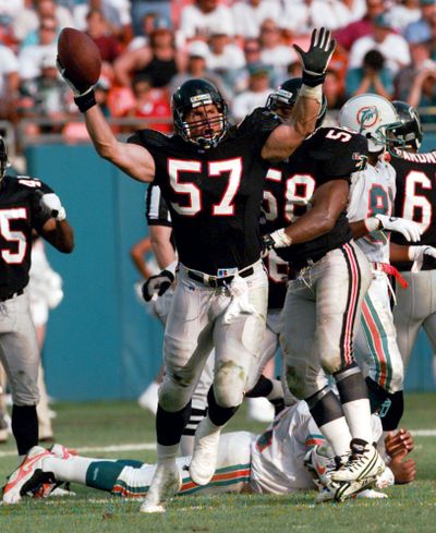 Atlanta's Clay Matthews celebrates after intercepting a pass from Miami QB Dan Marino in a 1995 NFL game. (Associated Press)