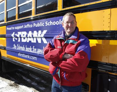Marc Horner, fleet manager for Jeffco Public Schools, stands next to a school bus at the schools’ bus maintenance facility in Lakewood, Colo., last month.  (Associated Press)