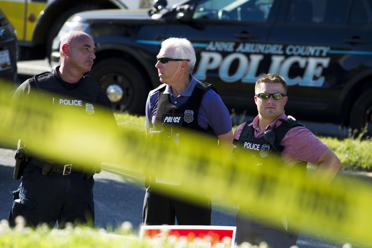 Police officers secure the area after five people were shot to death at The Capital Gazette newspaper in Annapolis, Md., Thursday, June 28, 2018. (Jose Luis Magana / Associated Press)