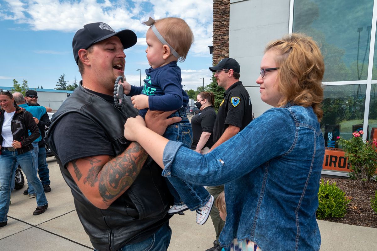 After ending a two-month motorcycle ride with The End of Watch Ride to Remember, Lance Drapeau greets his daughter Skylar, 14 months, and wife Melissa, on Thursday at the Lone Wolf Harley-Davidson in Spokane Valley.  (Colin Mulvany/THE SPOKESMAN-REVIEW)