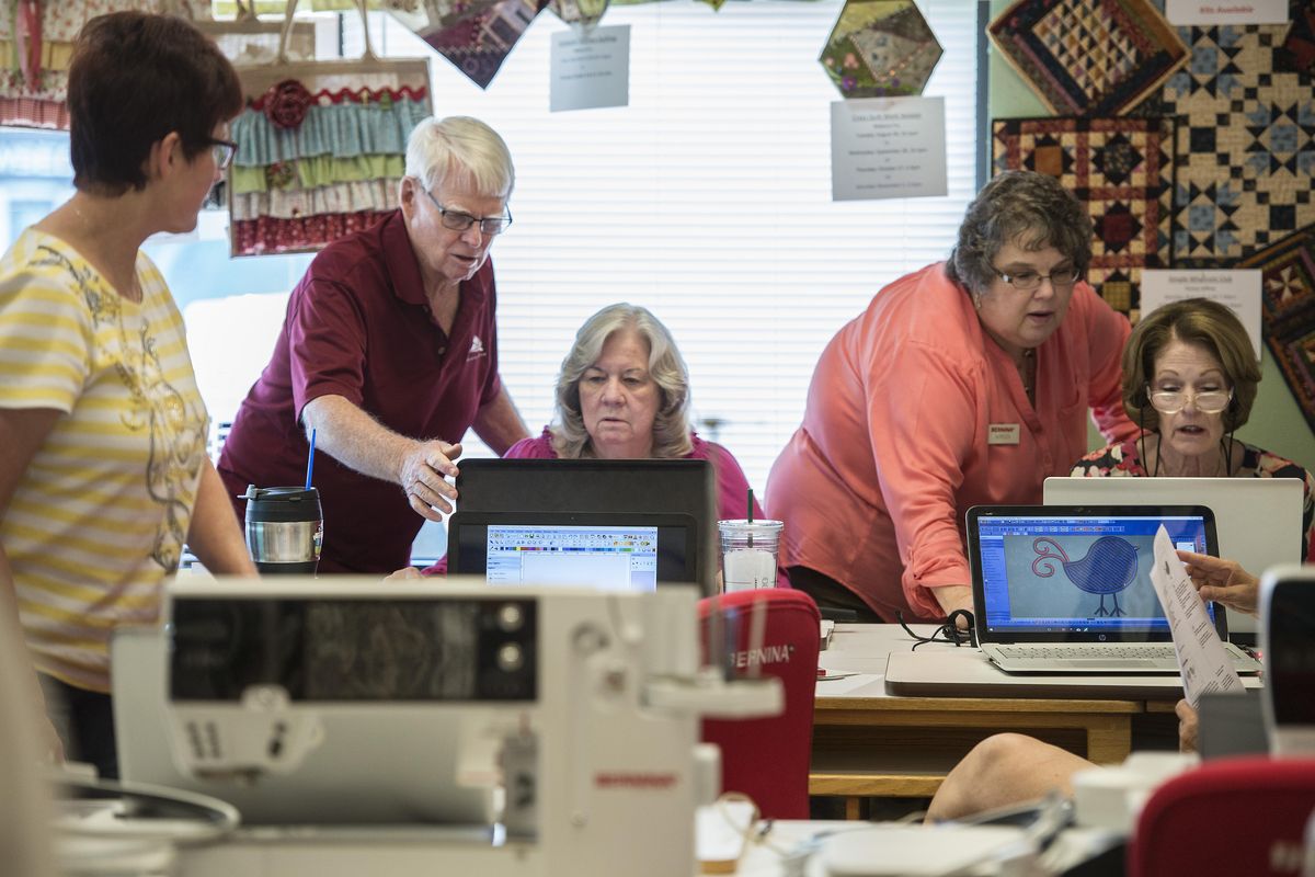Larry Brown participates in an embroidery class with Karen Browning, Noreen Skogen and Janie Bialkowsky, Aug. 16, 2016, at the Quilting Bee in Spokane, Valley, Wash. (Dan Pelle / The Spokesman-Review)