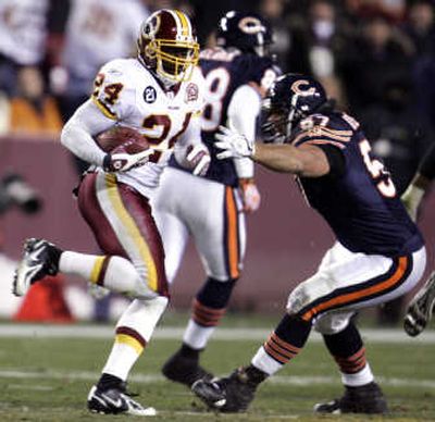 
Olin Kreutz of the Bears tries to stop Redskins' Shawn Springs during an interception return. Associated Press
 (Associated Press / The Spokesman-Review)